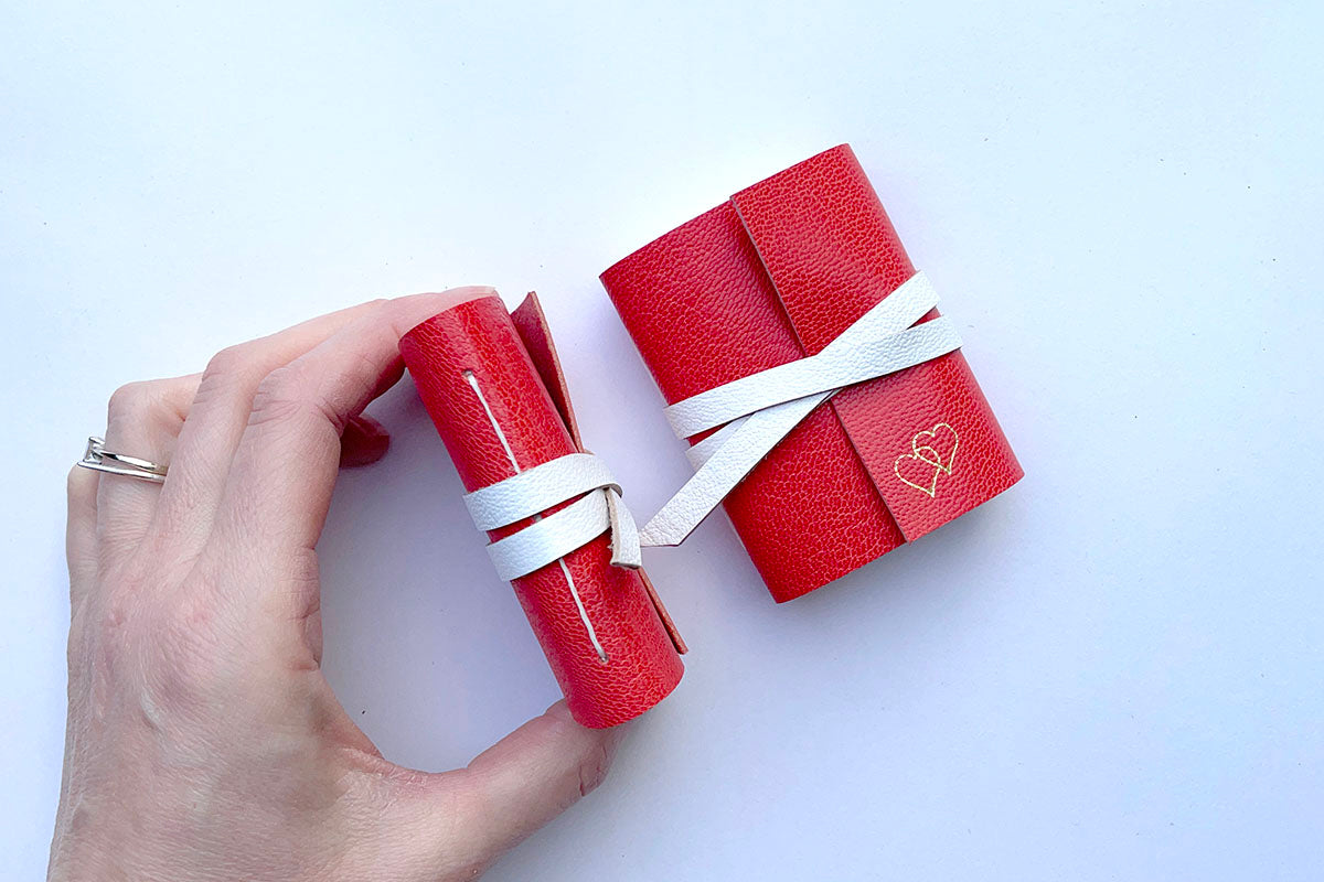 Hand stitched spine of Mini Leather Notebooks in Red and White with love hearts