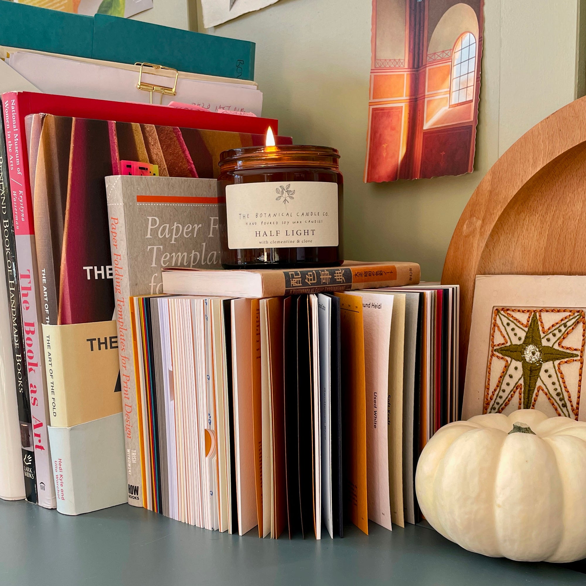 Autumnal display in a creative studio space, with resources on paper, colour theory, folding techniques and artist's books.
