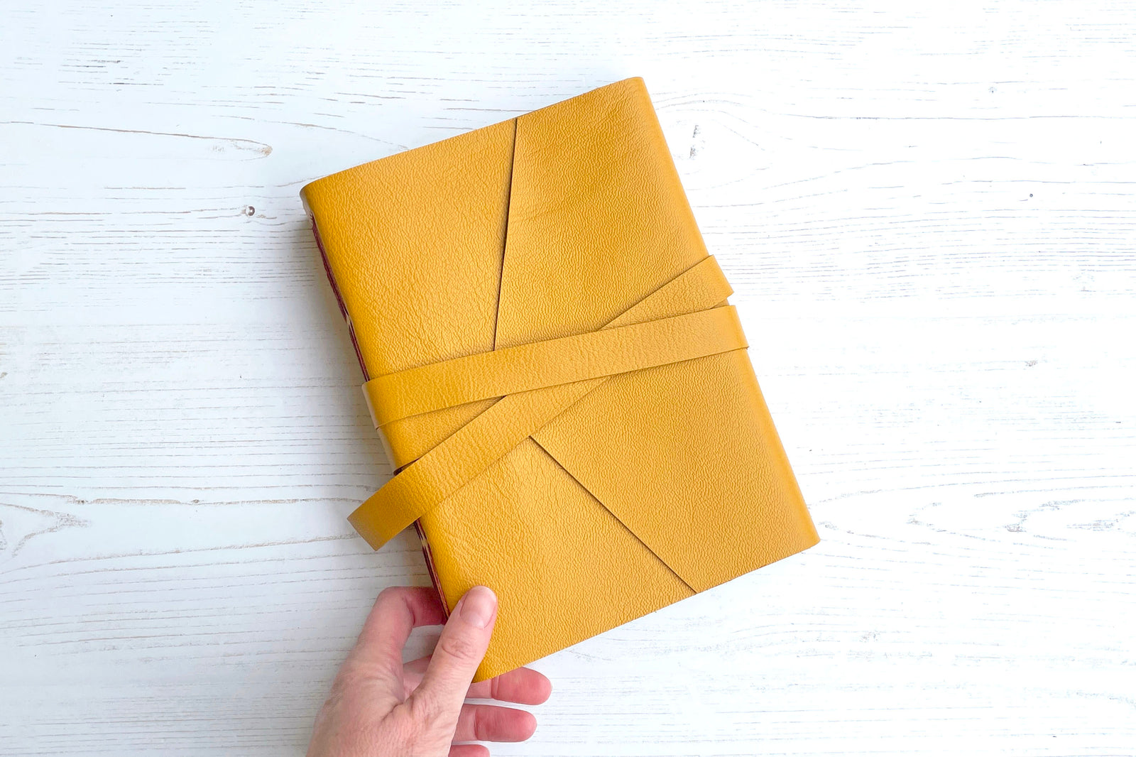 Lay flat leather sketchbook bound in Mustard Yellow with Rust exposed spine stitching, A5 medium portrait