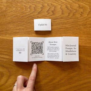 A QR code links to a blog post with full details of each of the 10 jouranling prompts with inspirational examples from artists, writers, coaches and psychologists.