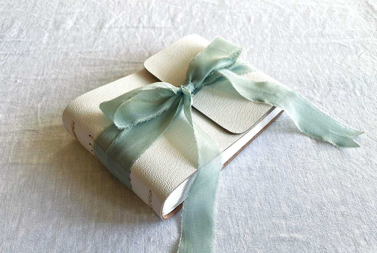 Personalised Baby Shower Guest Book in white leather with silk ribbon