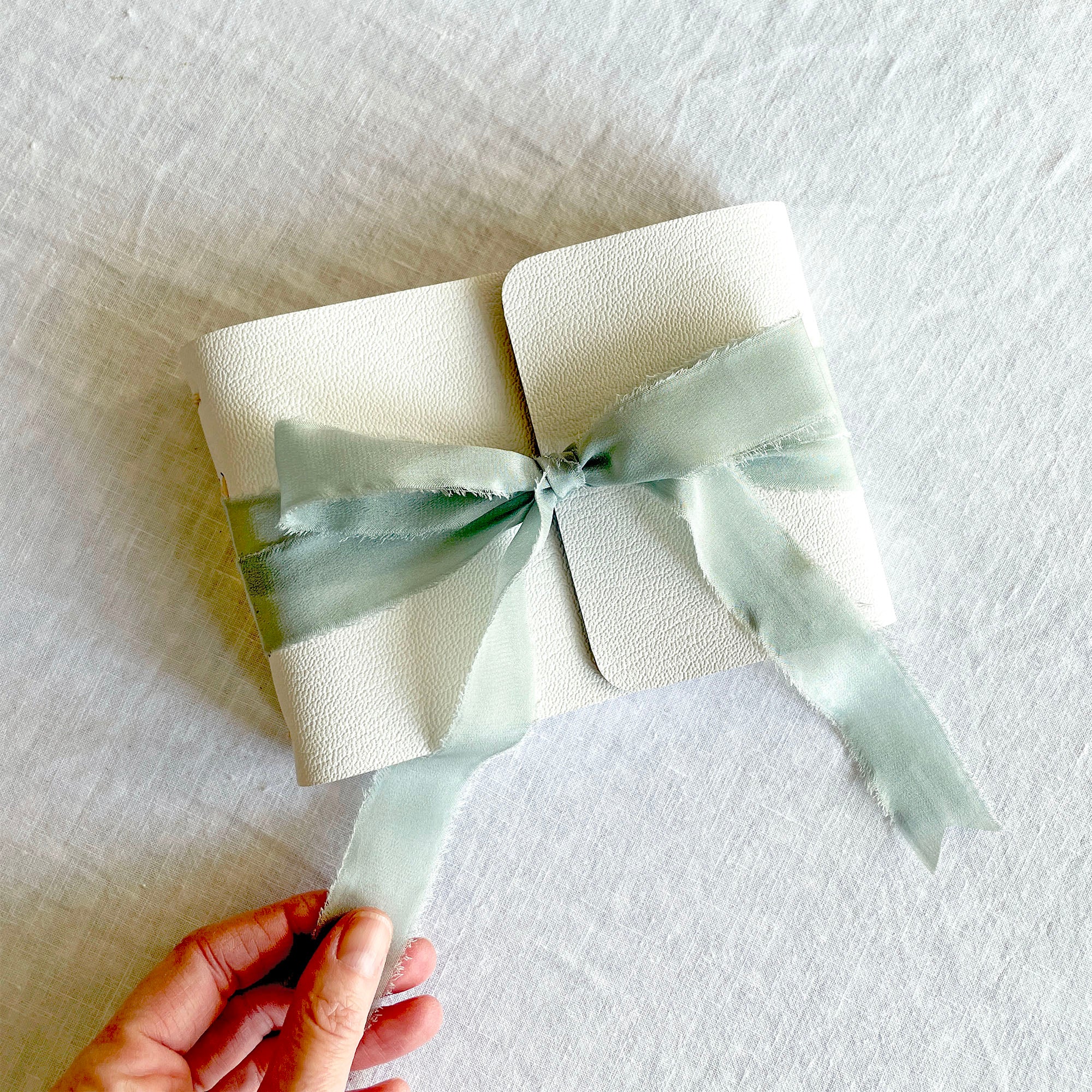 New Baby Book: White leather, raw edge silk ribbon bound at A6 small size