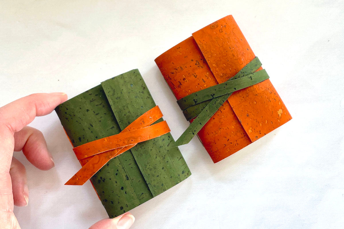 Mini Journals bound in Green and Orange sustainable cork fit in the palm of your hand