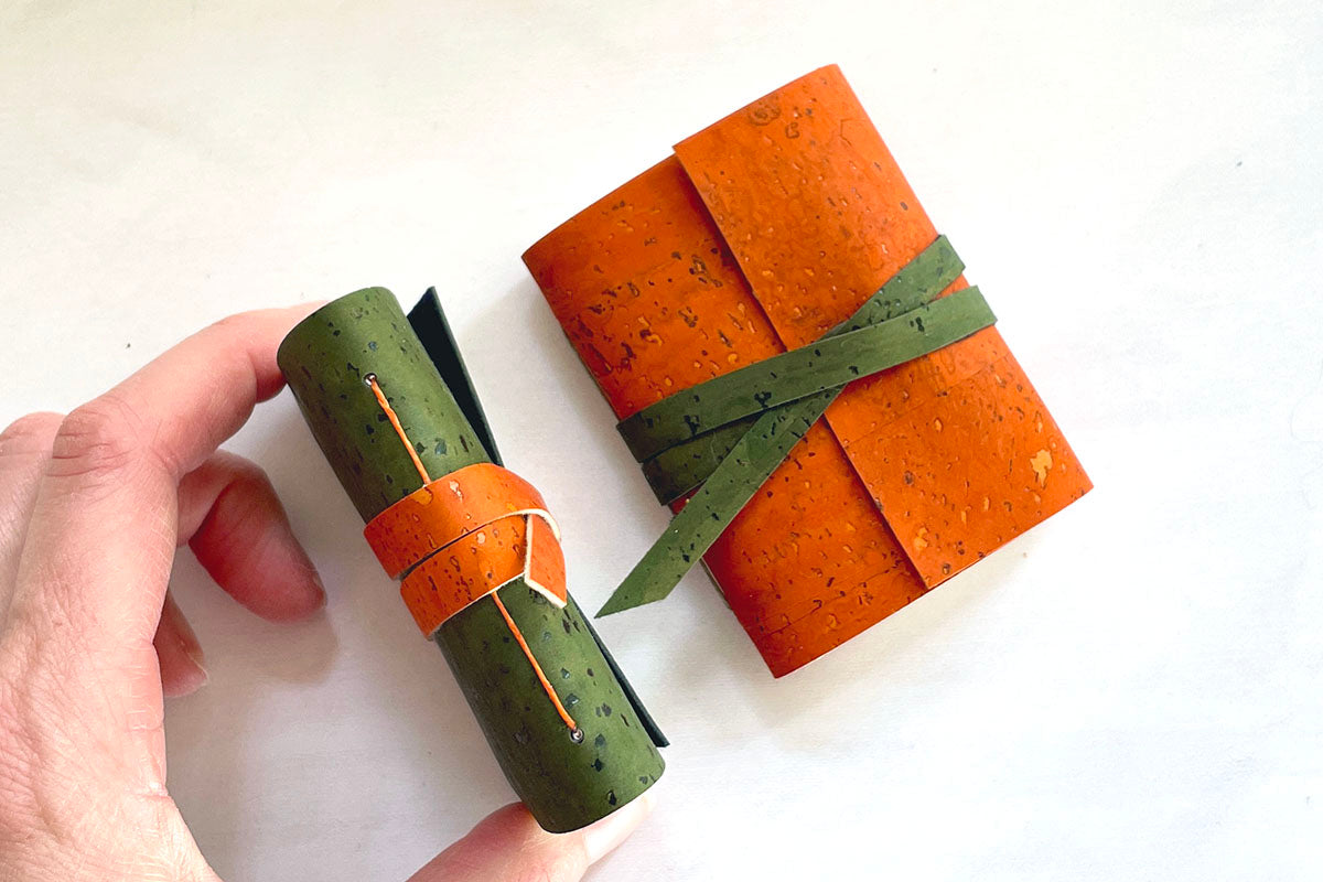 Mini Journals bound in Green and Orange sustainable cork fit in the palm of your hand