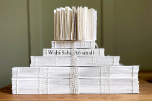 Stack of all Wabi Sabi Sketchbooks: exposed spine cotton rag art journals, A6 small named in black