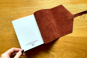 Colophon on final page of leather journal guarantees its bound by hand authenticity