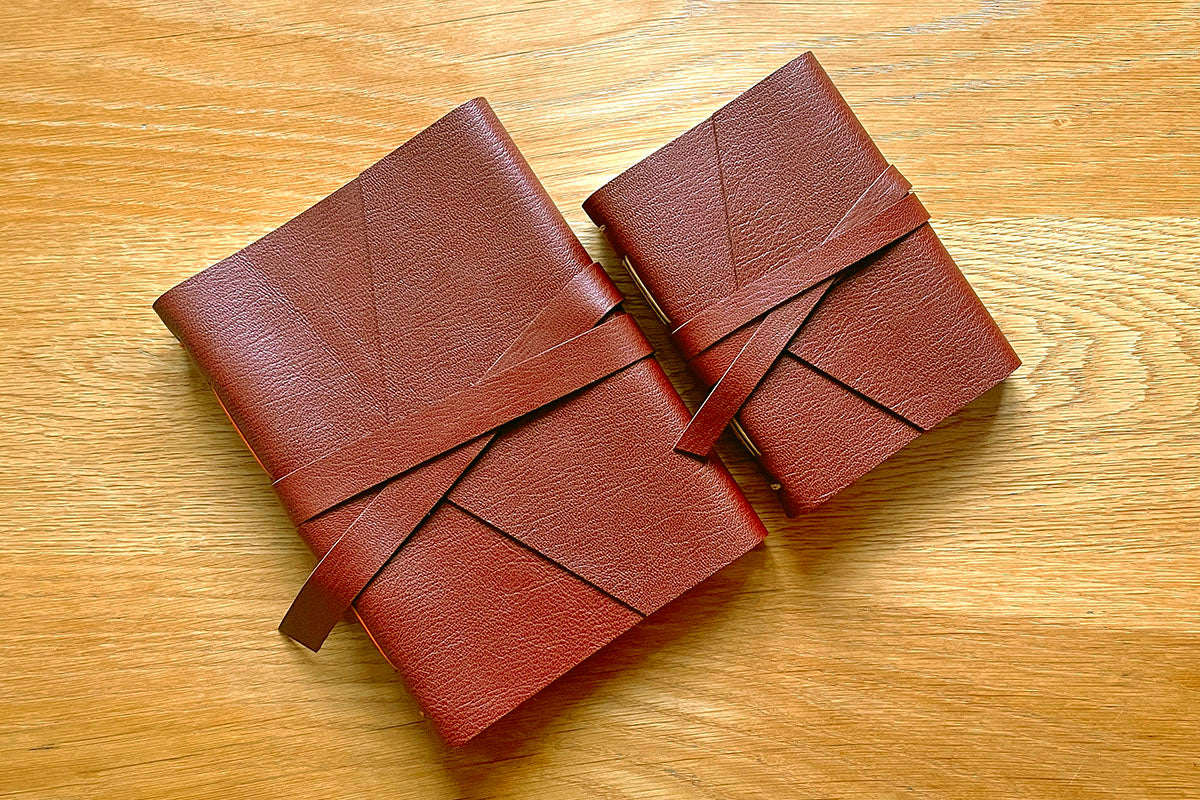 This A5 medium Oxblood leather journal is shown with the smaller A6 version stitched in Tan.
