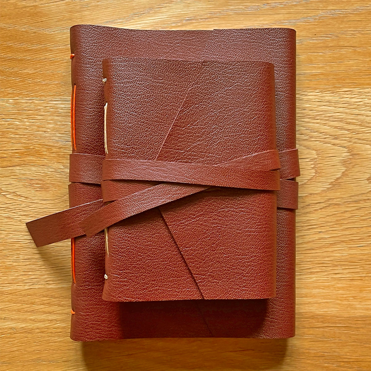 This A6 small leather journal sits atop the A5 version for comparison
