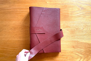 A soft leather strap is securely stitched to the Memory Book to keep it closed for storage