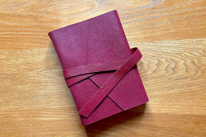 A5 portrait leather sketchbook with heritage style V cover flap and strap