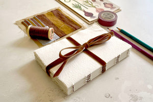 Lay flat exposed spine binding art journal bound with handmade cotton rag paper and brown velvet ribbon