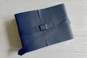 A4 Landscape Leather Memory Book bound in Navy Blue with strap and hand stitched buckle to close.