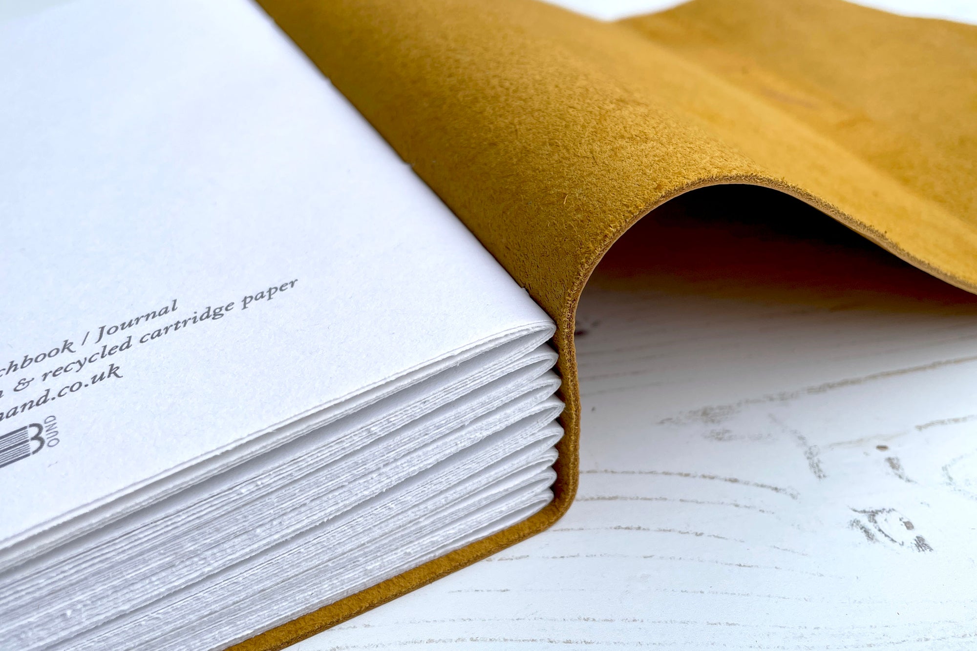 Discrete colophon printed on final page of limp leather sketchbook / art journal that is hand bound in Mustard Yellow.