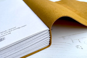 Discrete colophon printed on final page of limp leather sketchbook / art journal that is hand bound in Mustard Yellow.