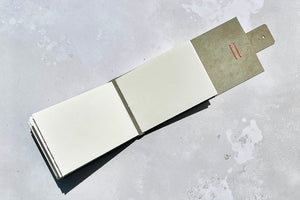 A6 landscape watercolour pages lay flat in a handmade leather sketchbook.