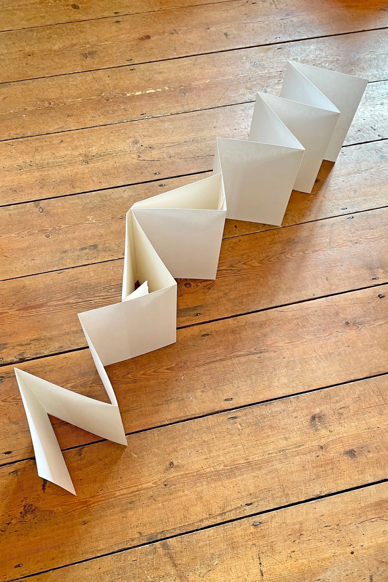 Concertina Sketchbook pages held securely by cottonrag over turn ins for travel or archiving.