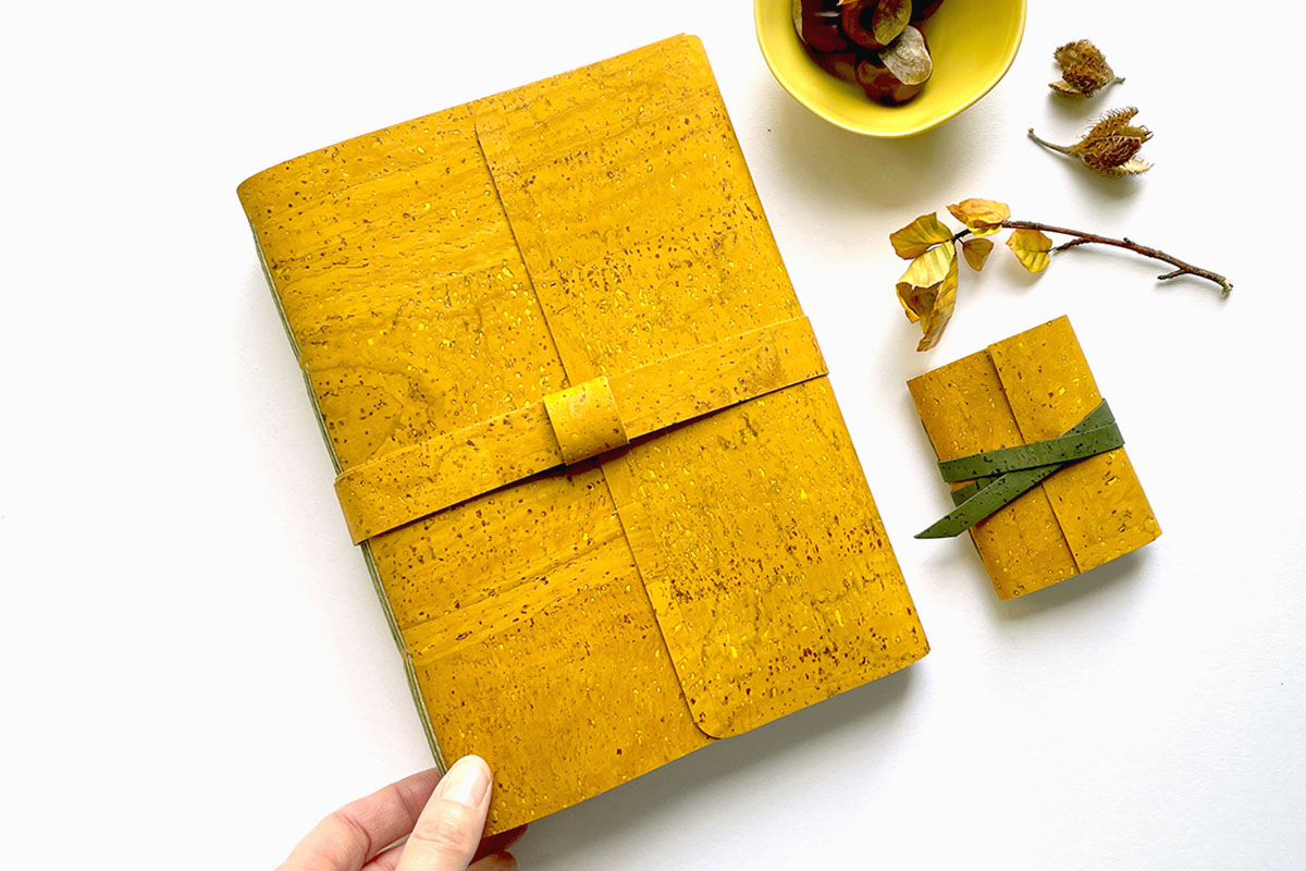 Cork Vegan Miniature Journal bound in Mustard Yellow and Forest Green, shown with full (A5) size matching journal.