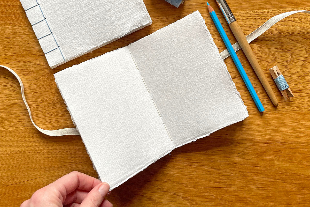 210gsm handmade cotton rag paper sketchbook is lay flat for drawing, painting and mixed media.