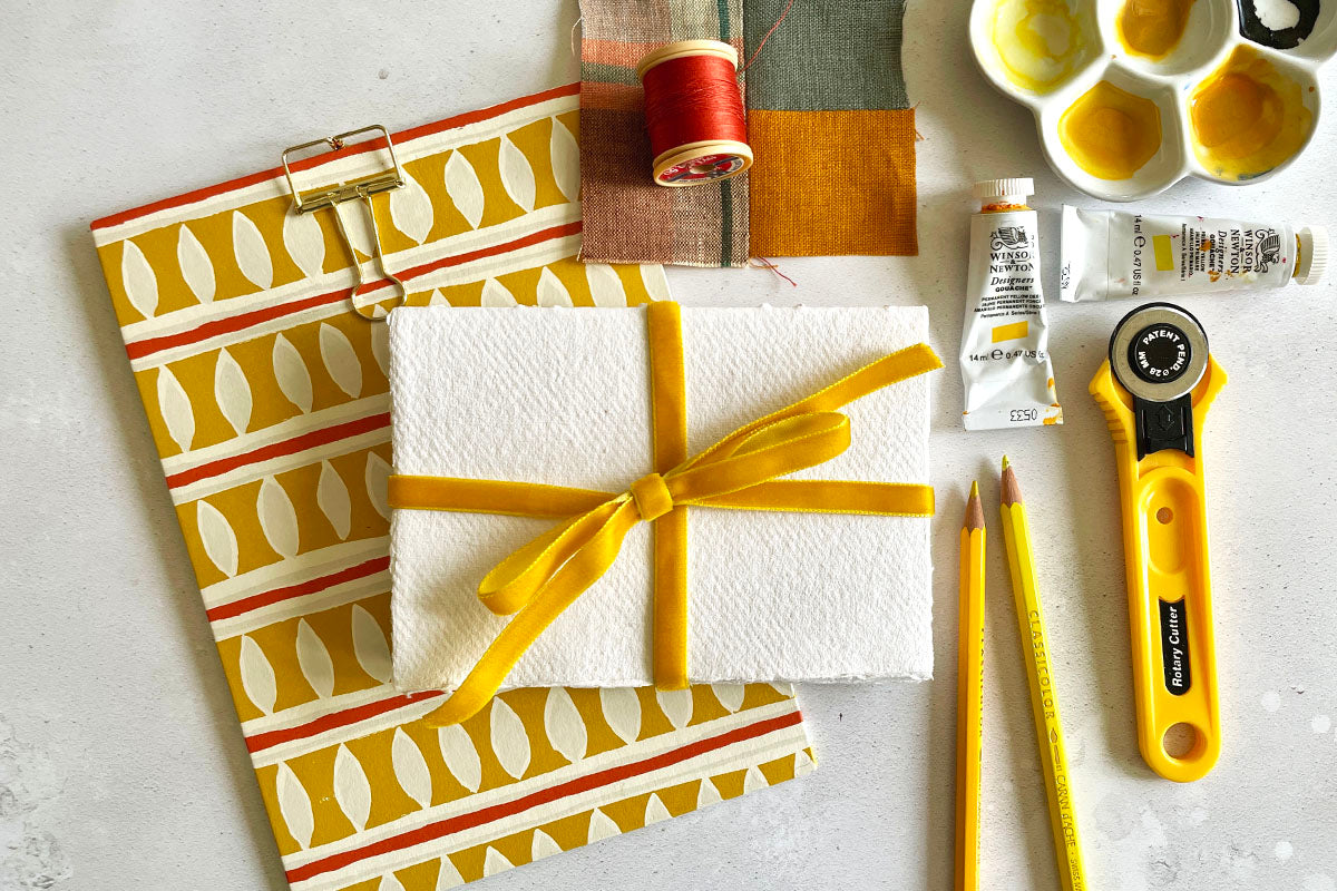 A6 Cotton Rag Sketchbook bound with Golden Yellow velvet ribbon and handmade paper with various art materials