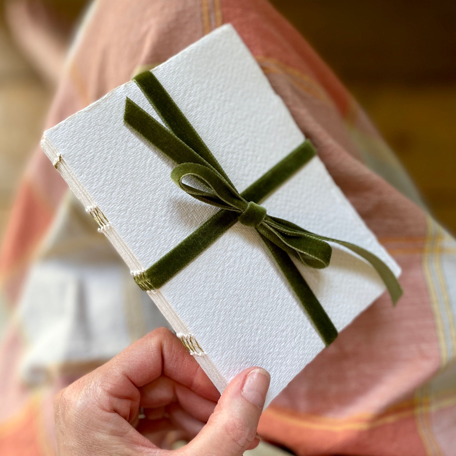 Cotton Rag Sketchbook bound with handmade recycled paper and olive green velvet ribbon tied in a bow