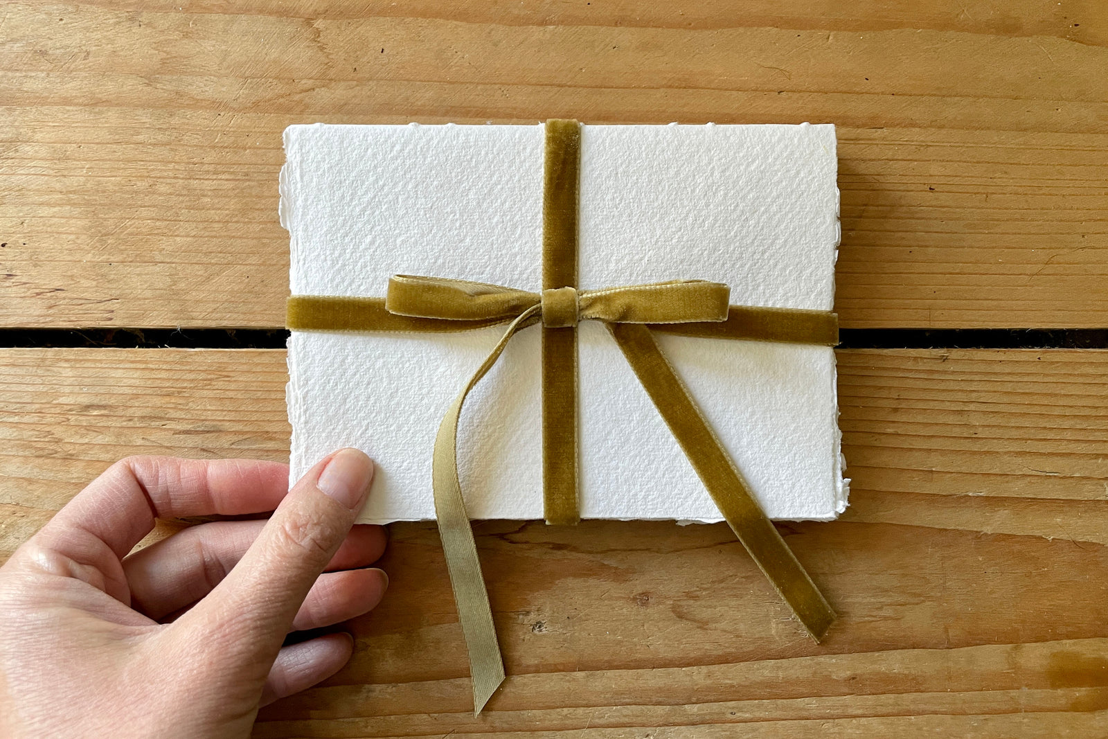 Cotton Rag Sketchbook bound with handmade recycled paper and olive green velvet ribbon tied in a bow