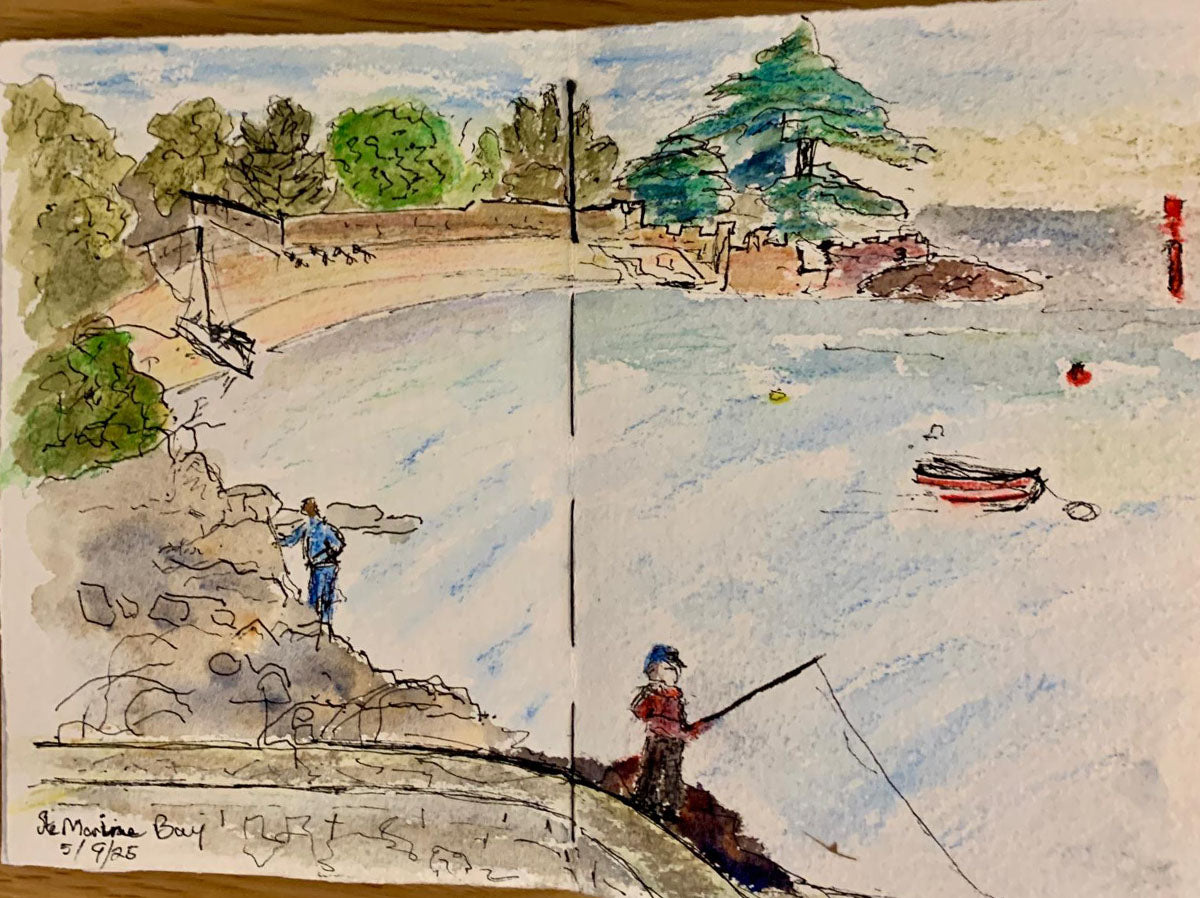 Handmade cotton rag sketchbook spread with watercolor painting of an ocean bay with people fishing and a boat.