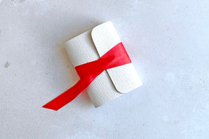 Miniature Journal bound in white leather with red silk ribbon, a handmade stationery gift for Valentine's Day or a first or third wedding anniversary.