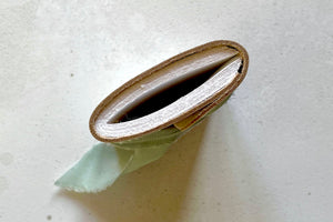 Traditional hand torn pages feature in this Mini Journal bound in white leather with sea mist silk ribbon