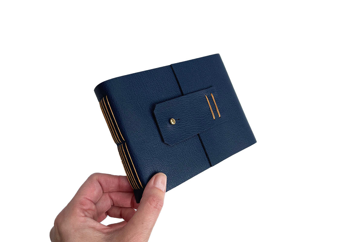 Sketchbook is ideal for travel, as a leather fob securely fits over a metal stud to keep closed.