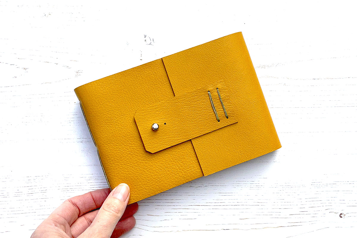 A6 small landscape Leather Sketchbook for watercolours, bound in Mustard Yellow with Olive Longstitch detail.