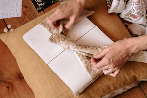 The ribbon is securely attached to the guest book's covers and ties in a bow for elegant display.