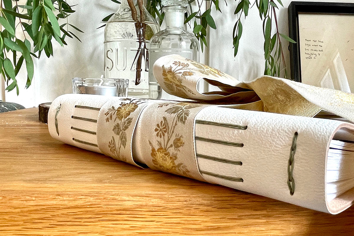 Wedding Guest Book with exposed spine binding allows lay flat pages to stay open for guests to write in the book.