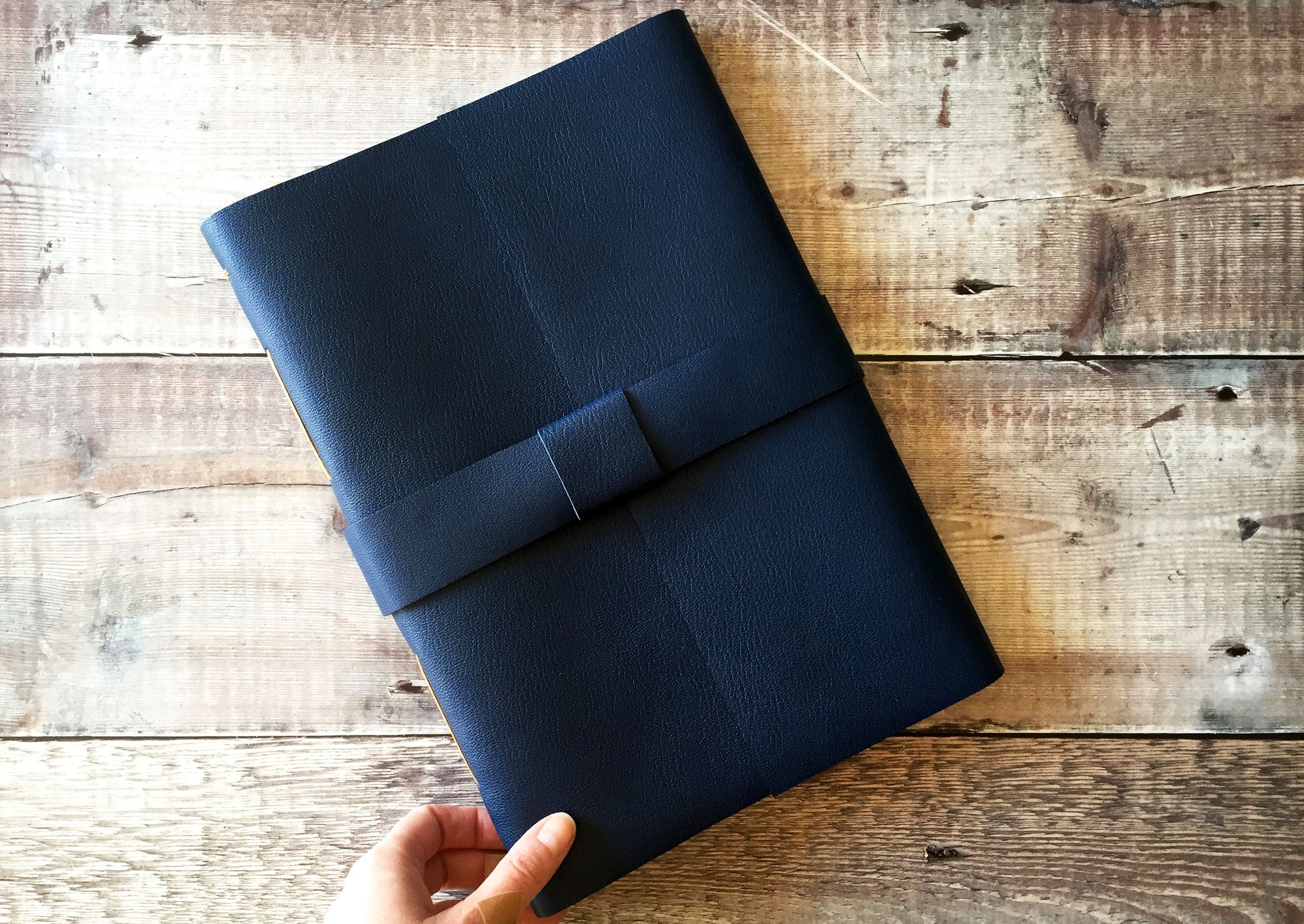 Leather strap and buckle keep this A4 handmade Leather Journal closed.