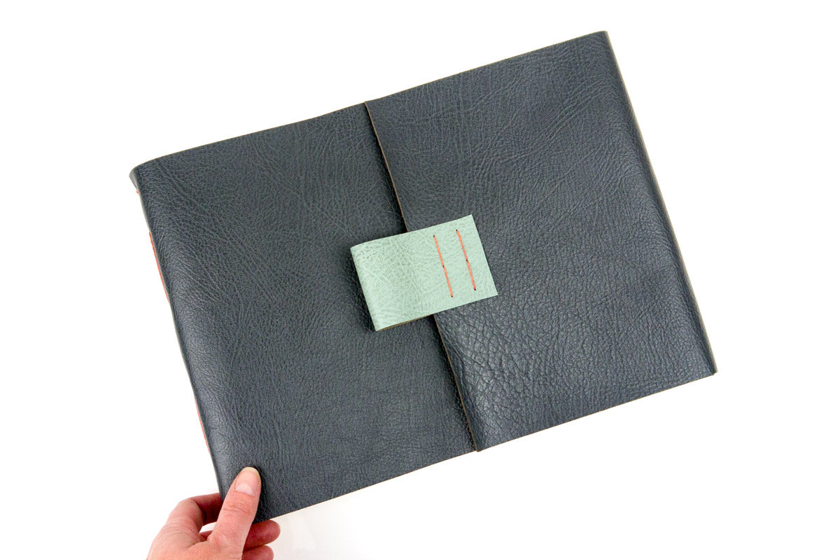 A4 Leather Sketchbook bound in Pewter Grey with a Duck Egg closing fob