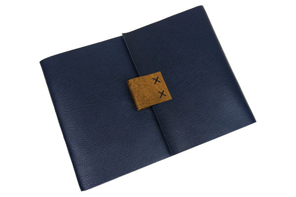 Navy Blue Leather Sketchbook with limp (soft) cover that drapes elegantly on a table.