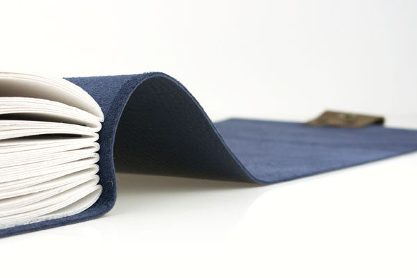 Navy Blue Leather Sketchbook with limp (soft) cover that drapes elegantly on a table.
