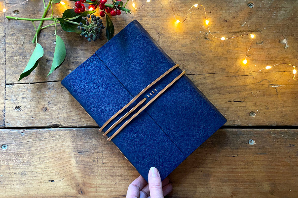 Leather Sketchbook bound in Navy Blue leather with Tan thong, A5 portrait. A practical Christmas gift for artists.