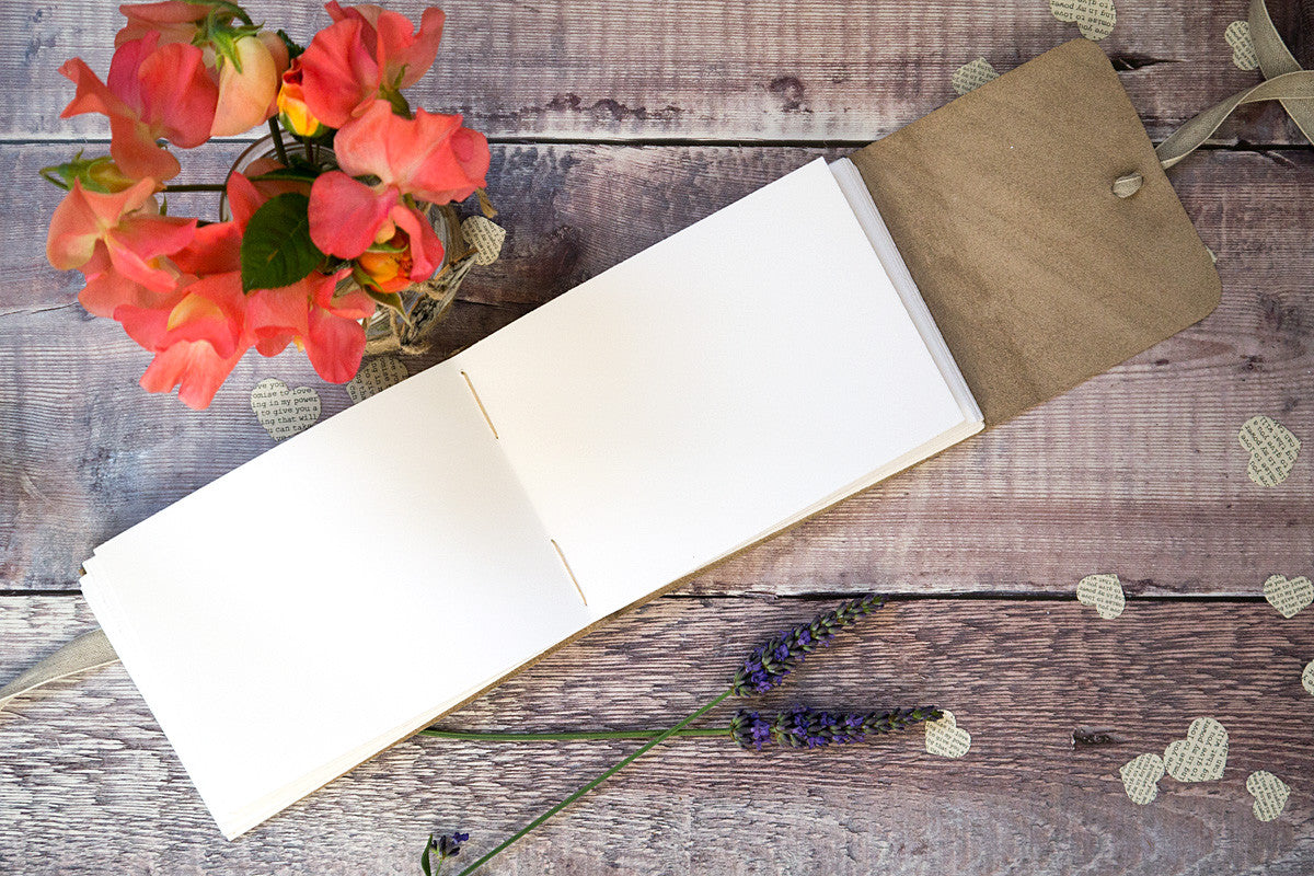 Hand sewn pages lie open to receive your guests' well wishes in this leather Wedding Guest Book