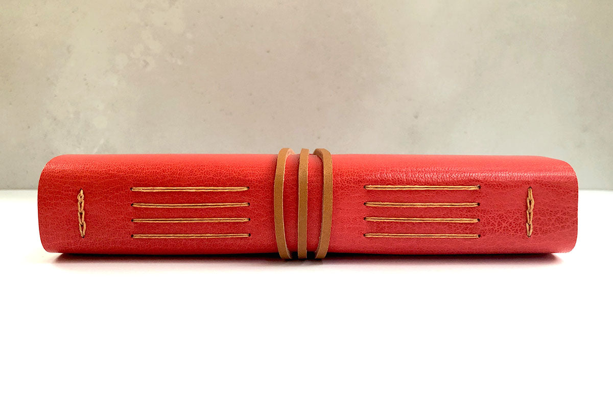 Spine of Longstitch with Linkstitch red leather bound notebook