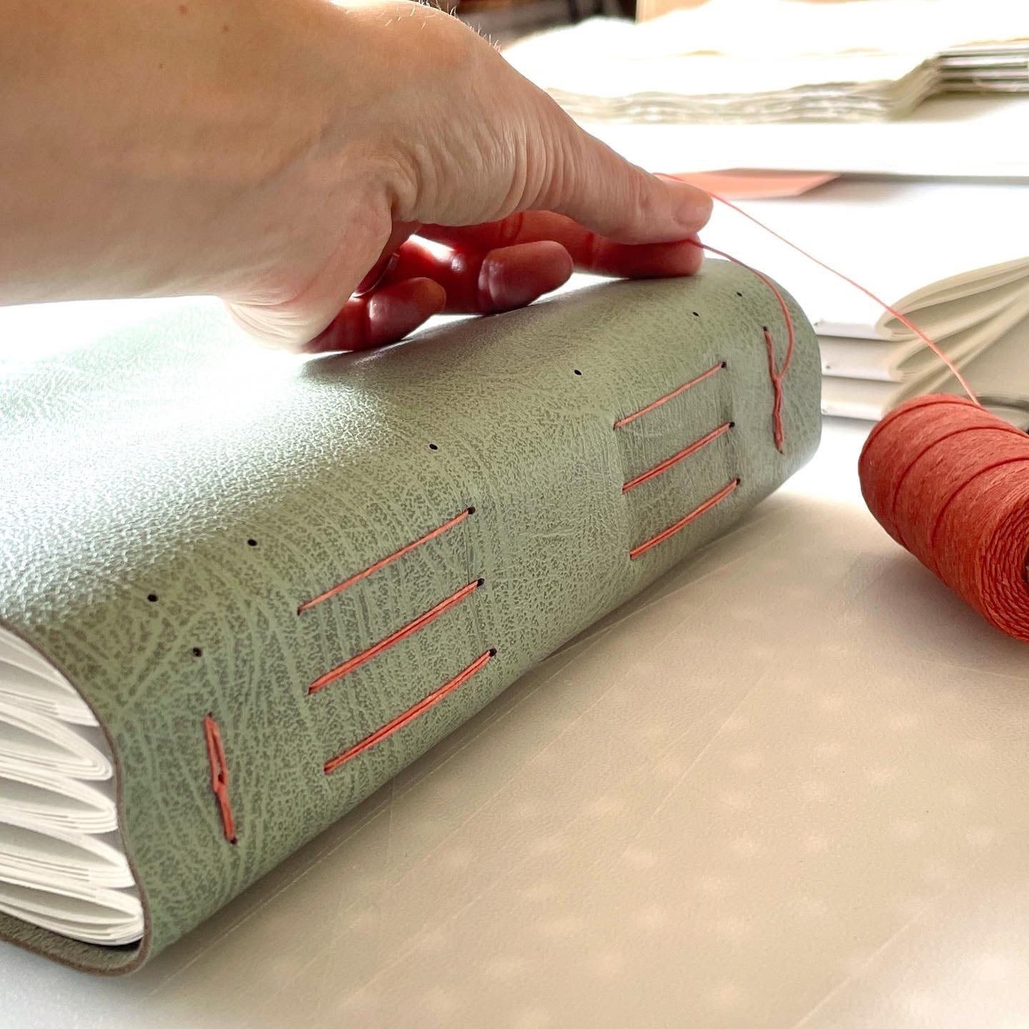 Pages are sewn through the leather to make a softcover, flexible book that's extremely durable so it will last through the generations.